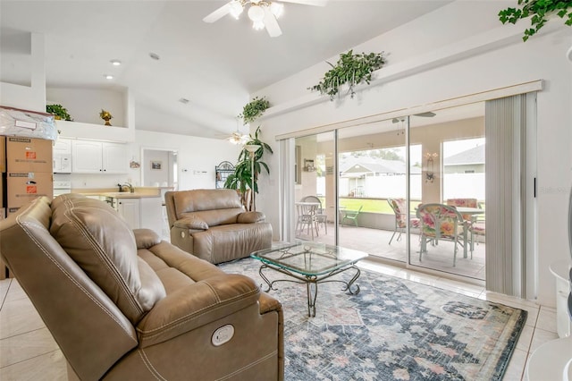 tiled living room featuring ceiling fan, sink, and vaulted ceiling