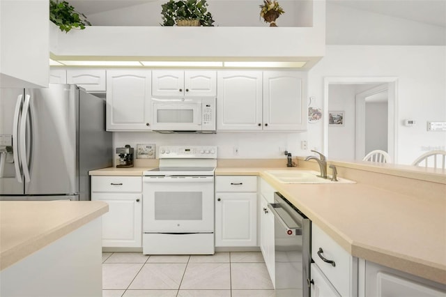 kitchen featuring white cabinets, vaulted ceiling, and stainless steel appliances