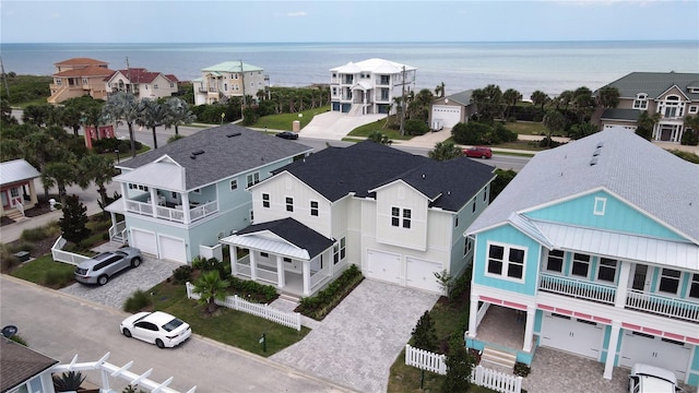 birds eye view of property with a water view and a residential view