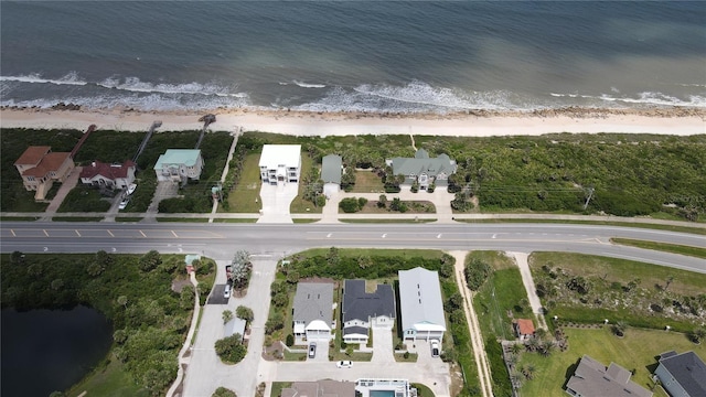 birds eye view of property with a water view, a residential view, and a view of the beach