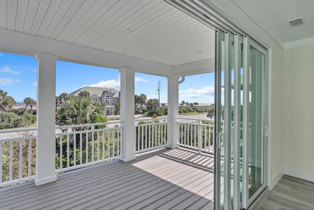 wooden deck with a residential view and visible vents