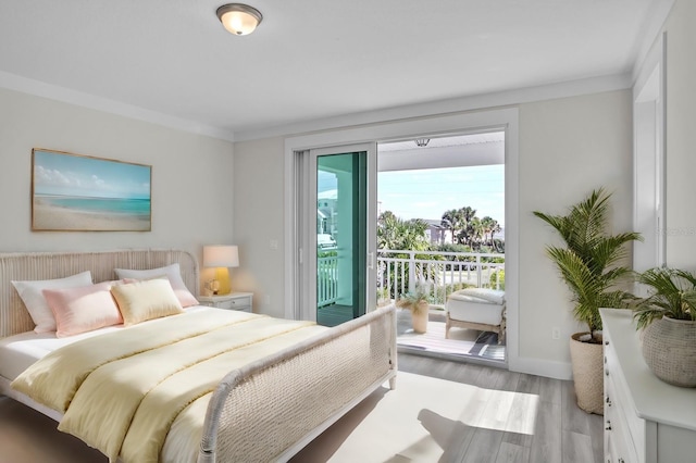 bedroom featuring access to exterior, ornamental molding, light wood-style flooring, and baseboards