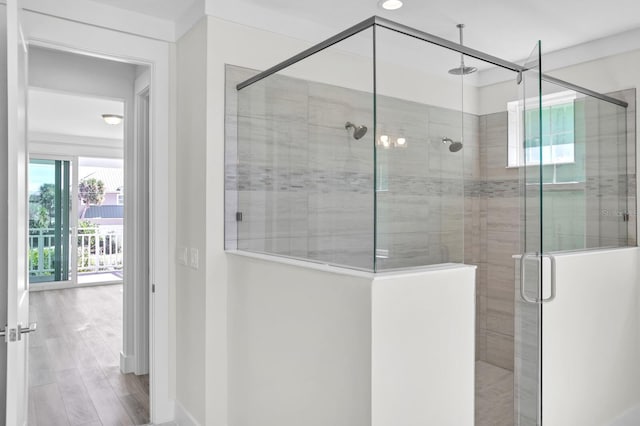 bathroom featuring a stall shower and wood finished floors