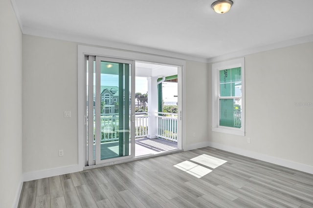 empty room featuring light wood-style floors and baseboards