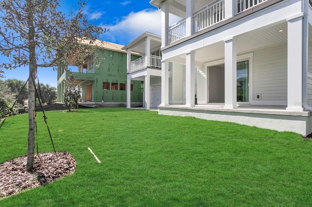 view of yard with a balcony