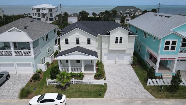 drone / aerial view featuring a residential view and a water view