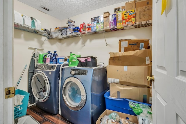 washroom with separate washer and dryer and a textured ceiling