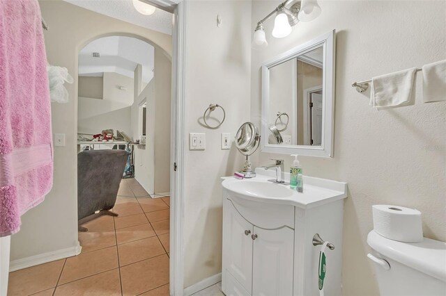 bathroom with vanity, tile patterned flooring, and toilet