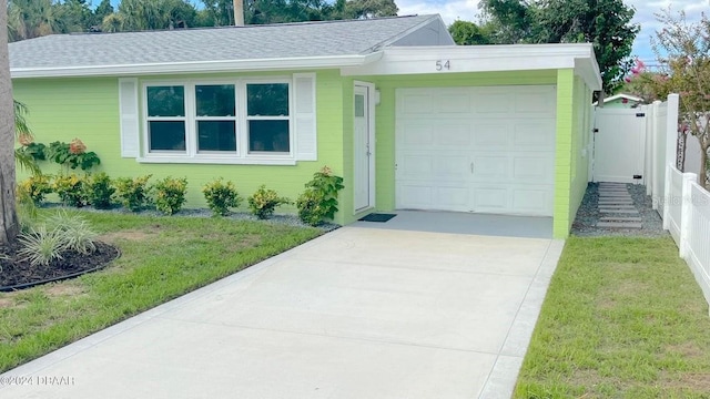 ranch-style home with a front lawn and a garage