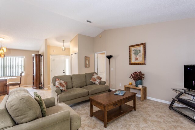 living room with lofted ceiling and light tile patterned floors