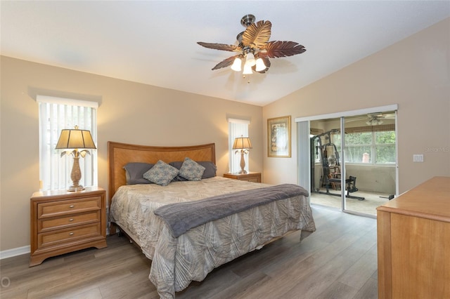 bedroom with hardwood / wood-style flooring, access to exterior, lofted ceiling, and ceiling fan