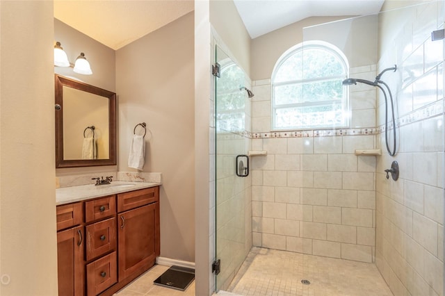 bathroom with vanity, vaulted ceiling, tile patterned floors, and walk in shower