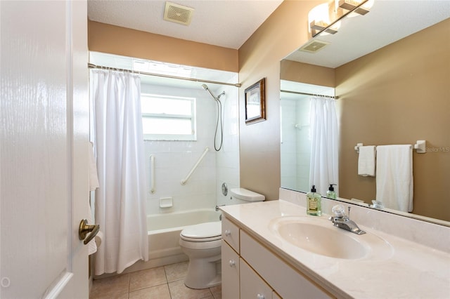 full bathroom with toilet, a textured ceiling, shower / bath combo with shower curtain, tile patterned floors, and vanity