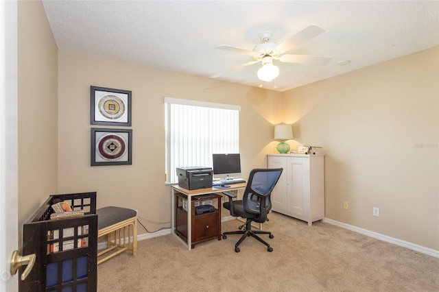 carpeted office with a textured ceiling and ceiling fan