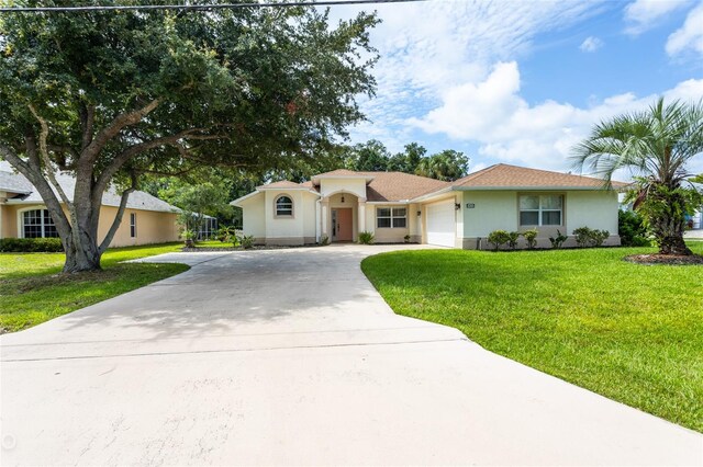 ranch-style home with a garage and a front yard