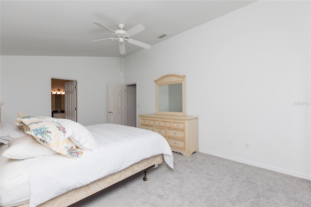 carpeted bedroom with connected bathroom, vaulted ceiling, and ceiling fan