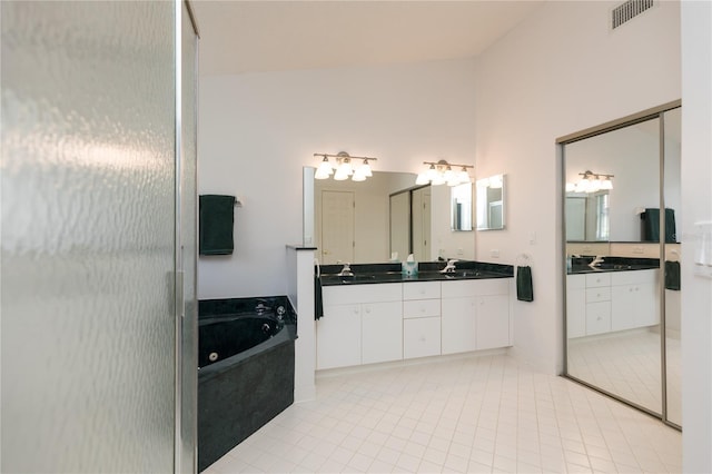 bathroom with vanity, tile patterned floors, and plus walk in shower