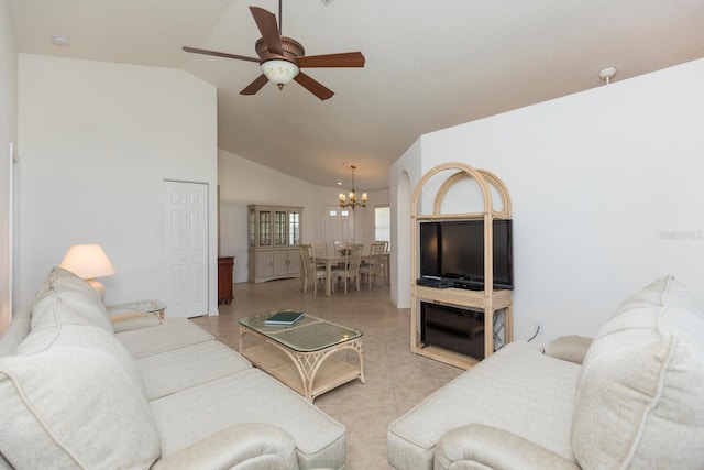 tiled living room featuring lofted ceiling and ceiling fan with notable chandelier