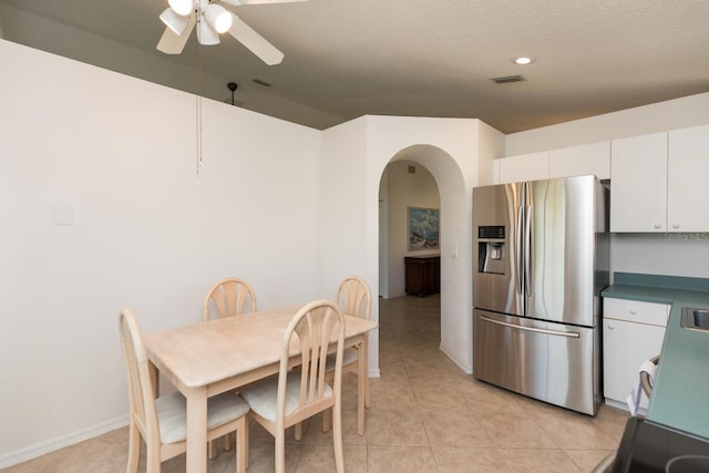 dining area featuring ceiling fan, a textured ceiling, and light tile patterned floors