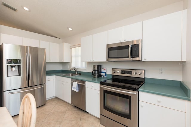 kitchen featuring white cabinetry, sink, a textured ceiling, and appliances with stainless steel finishes