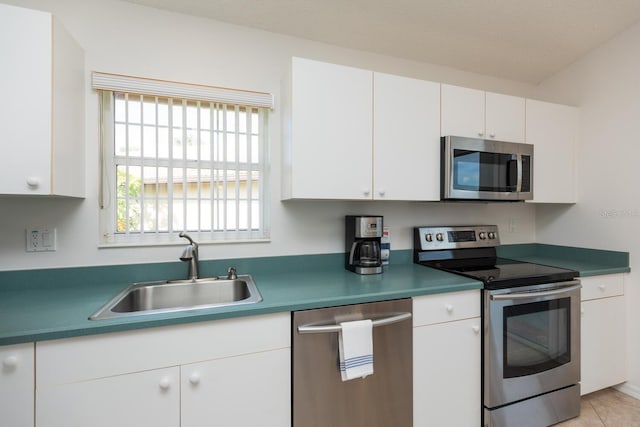 kitchen with white cabinetry, sink, a textured ceiling, and appliances with stainless steel finishes