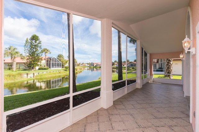 unfurnished sunroom with a water view