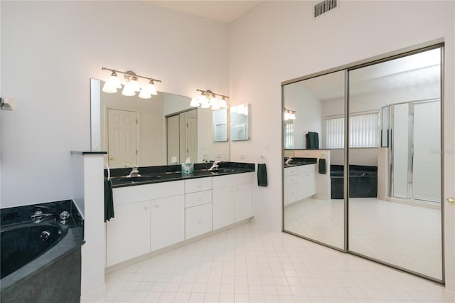 bathroom with vanity, a bathing tub, and tile patterned floors