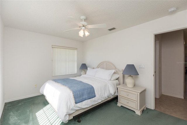 bedroom with ceiling fan and dark colored carpet