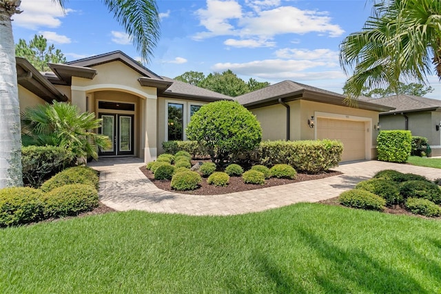 view of front of property featuring a garage and a front yard