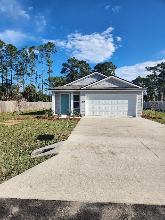 ranch-style house featuring a front lawn and a garage