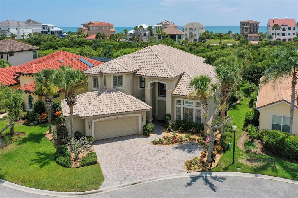 view of front of house featuring a garage and a water view