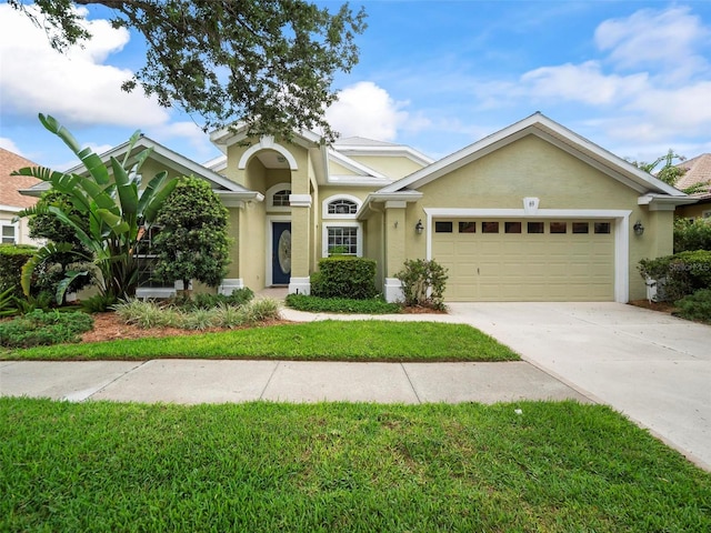 view of front of home with a garage and a front yard