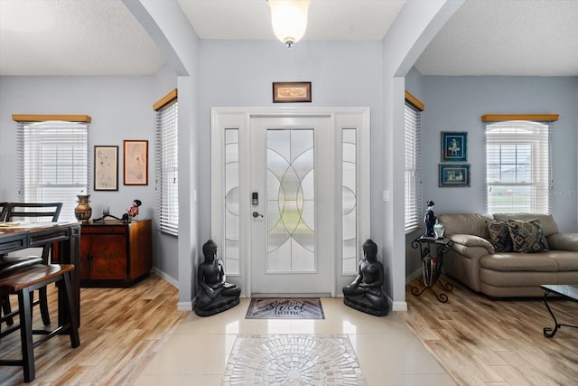 tiled foyer entrance featuring a textured ceiling