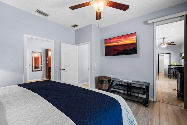 bedroom with light tile patterned flooring, a textured ceiling, and ceiling fan