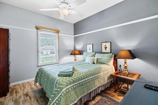 bedroom featuring ceiling fan and hardwood / wood-style floors