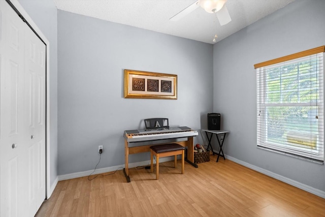 miscellaneous room with ceiling fan, a textured ceiling, and light hardwood / wood-style floors