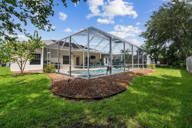 view of swimming pool featuring glass enclosure, a yard, and a patio