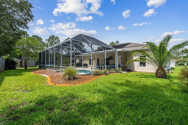 rear view of property featuring a lanai, a patio area, and a lawn