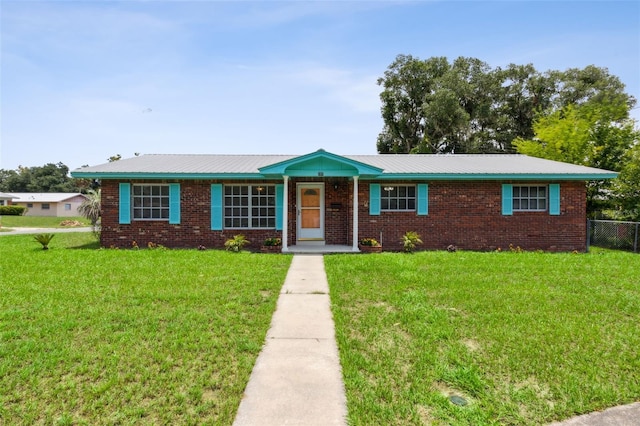 ranch-style house featuring a front lawn