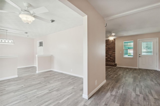 empty room featuring light wood-type flooring and ceiling fan