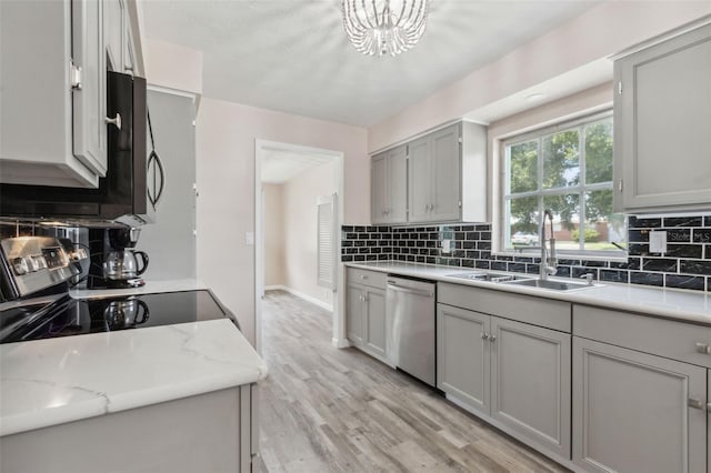 kitchen with light wood-type flooring, black appliances, sink, and gray cabinets