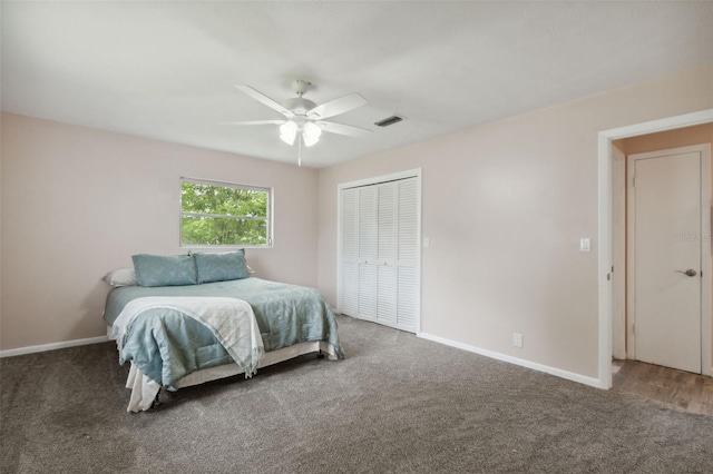 carpeted bedroom featuring ceiling fan and a closet