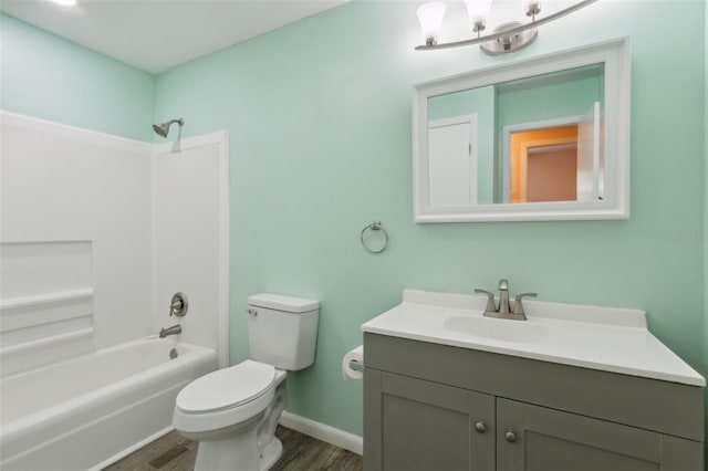 full bathroom with bathing tub / shower combination, vanity, toilet, and hardwood / wood-style flooring