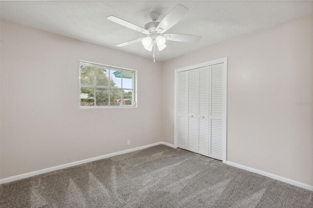 unfurnished bedroom featuring a closet, carpet, and ceiling fan