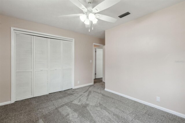 unfurnished bedroom with ceiling fan, light colored carpet, and a closet