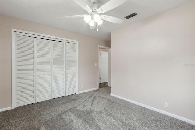 unfurnished bedroom featuring light carpet, ceiling fan, and a closet