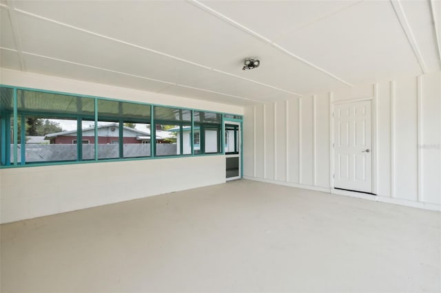 empty room with plenty of natural light and concrete flooring