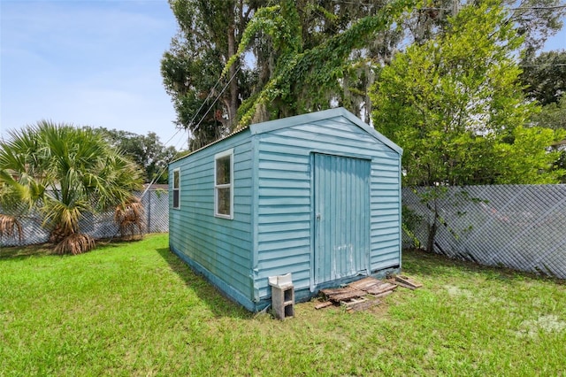 view of outdoor structure featuring a lawn