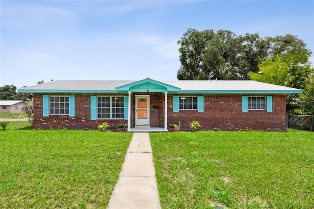 ranch-style home with a front lawn