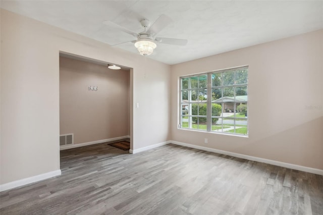 unfurnished room with hardwood / wood-style floors and ceiling fan